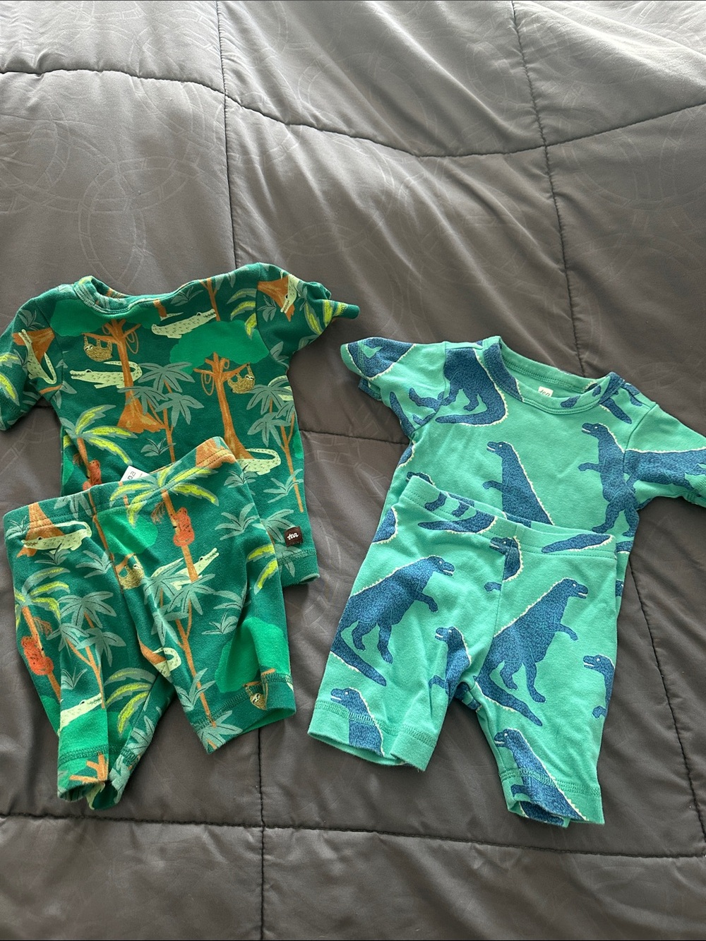 Tea Collection Green Dinosaur & Jungle Print two piece short pajama sets.